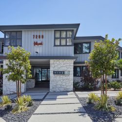 The exterior Hayden on Hollywood Boulevard ; LA apartment building with rock garden beds in the front