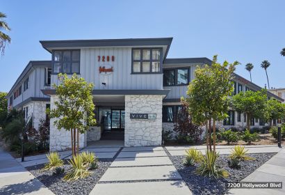 The exterior Hayden on Hollywood Boulevard ; LA apartment building with rock garden beds in the front