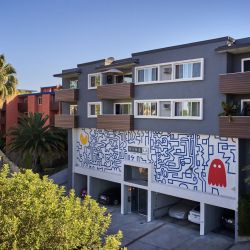 The exterior of Ethan on Evans apartment building with mural on the wall; Blu on Burns Properties in Silver Lake, LA.
