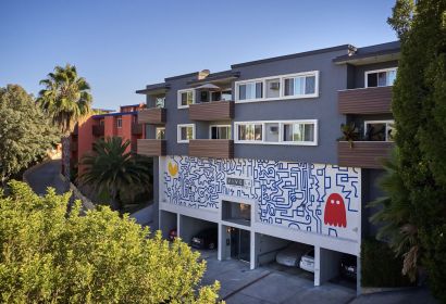The exterior of Ethan on Evans apartment building with mural on the wall; Blu on Burns Properties in Silver Lake, LA.