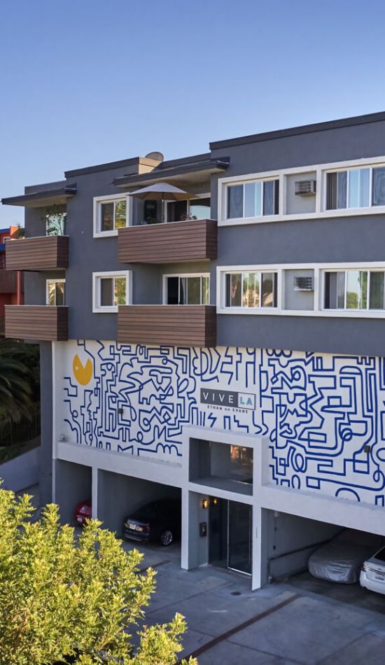 The exterior of Ethan on Evans apartment building with mural on the wall; Blu on Burns Properties in Silver Lake, LA.