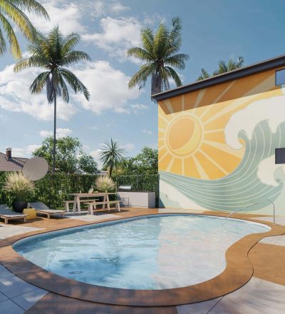 Outdoor pool next to apartment building with a mural wall art
