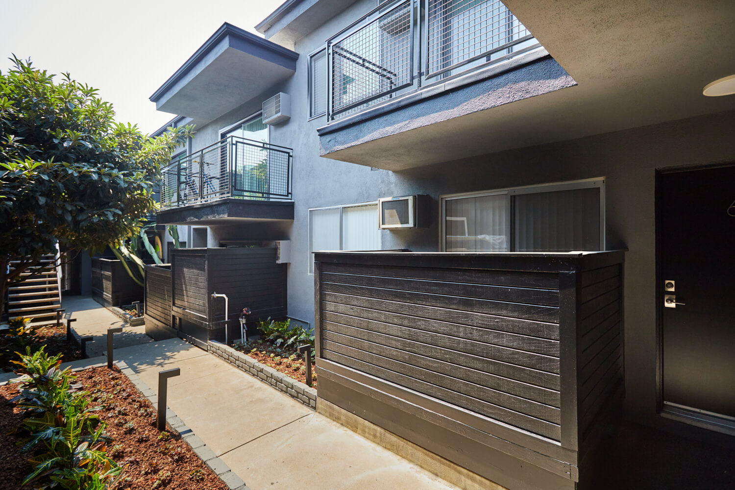 The walkway behind the Beau on Bundy apartment building