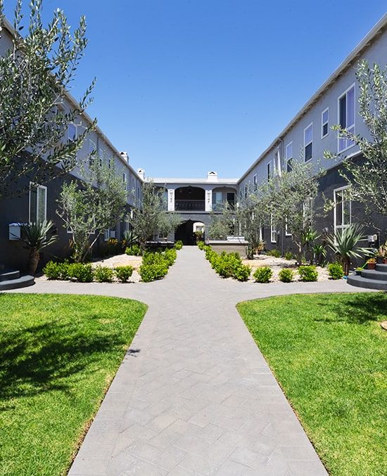 Blu on Burns courtyard with lush green spaces and trees