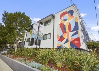 Apartments in West Hollywood; Callie on Curson exterior with a wall mural and raised garden beds in the front