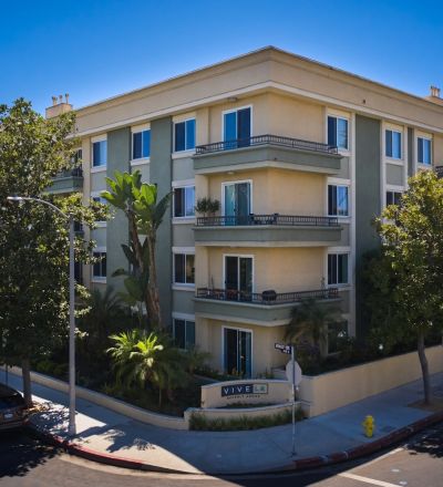 Exterior of Beverly Arnaz apartment building in a tree-lined street