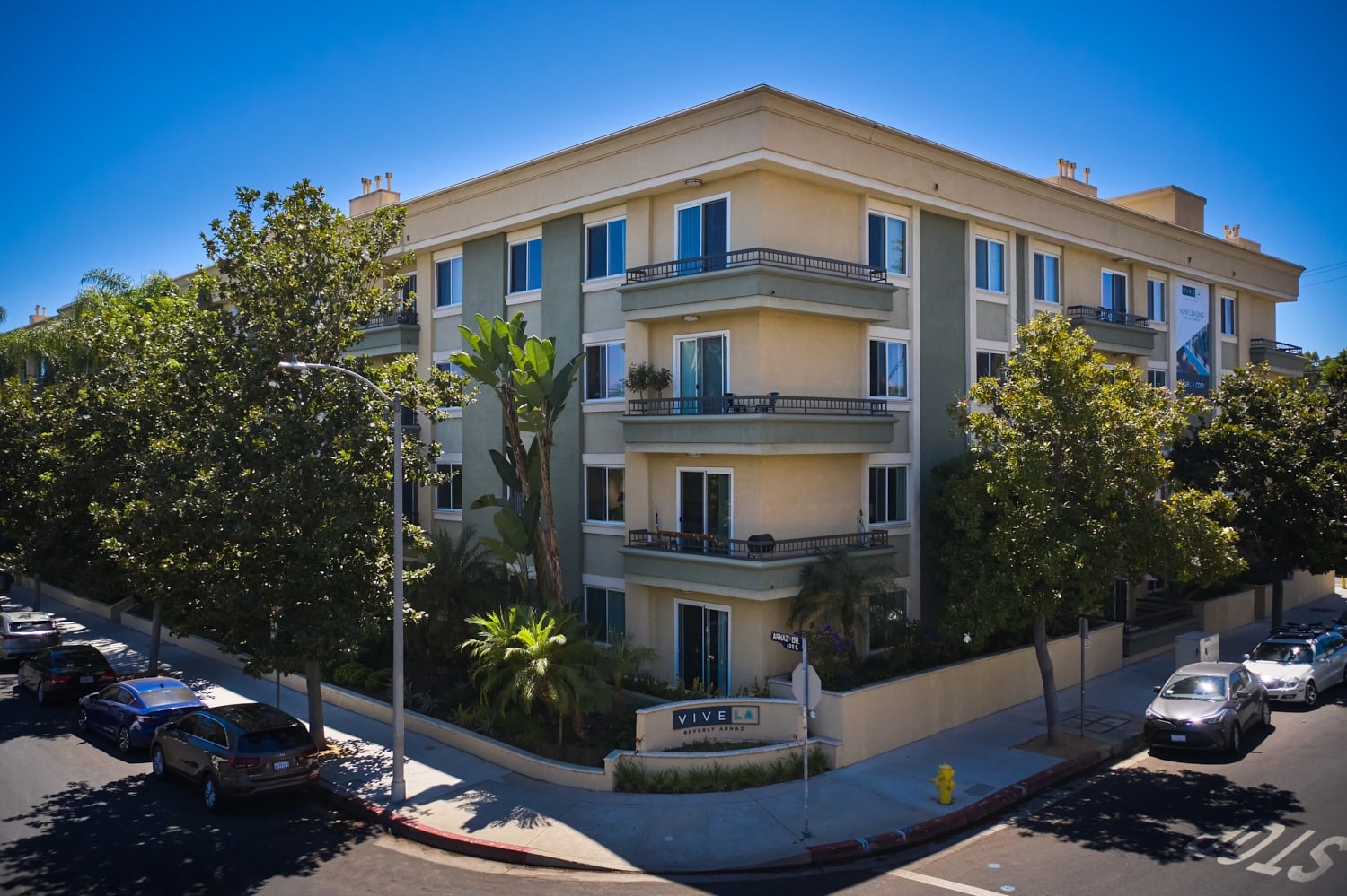 Exterior of Beverly Arnaz apartment building in a tree-lined street