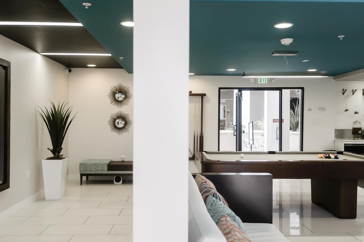 Communal entertainment area with a pool table and sitting space at Park Encino apartments