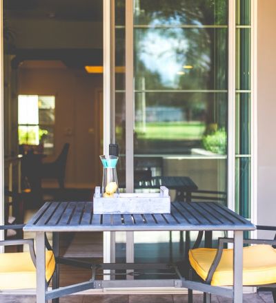 Dark washed wooden table with chairs at Park Encino apartment's patio area