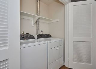 Laundry closet with washer and dryer lined together at Park Encino apartments