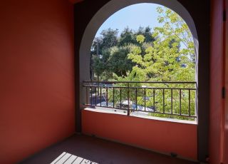 Curved patio window with iron rails at Park Encino apartments