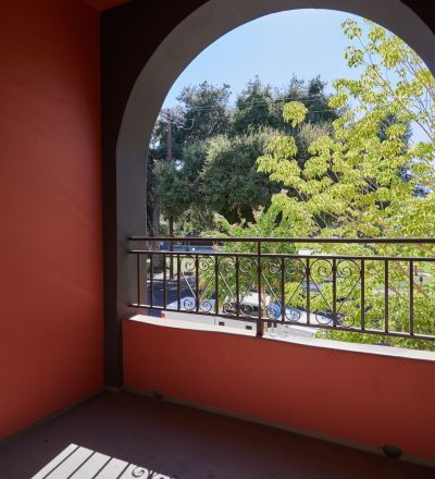 Curved patio window with iron rails at Park Encino apartments