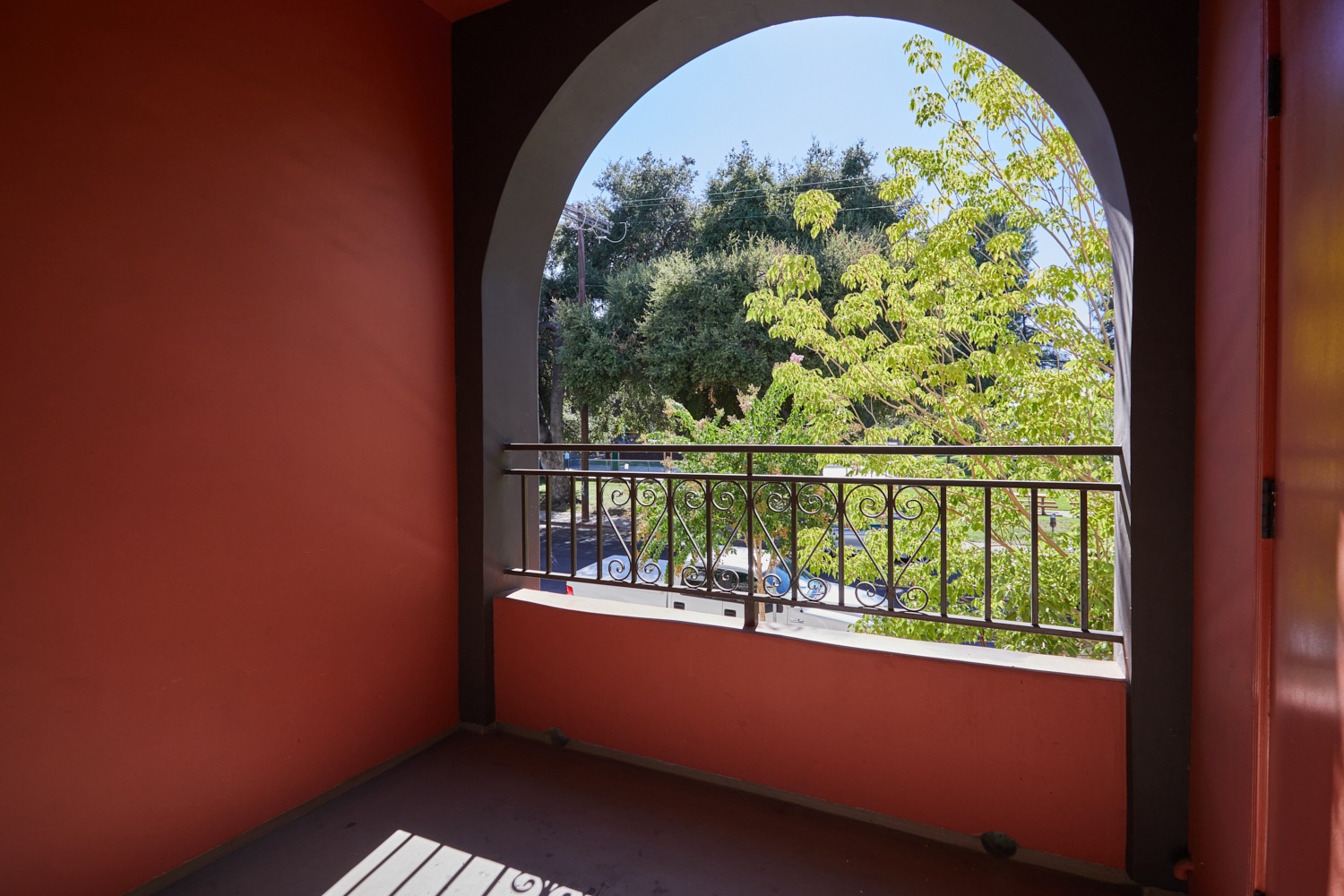Curved patio window with iron rails at Park Encino apartments