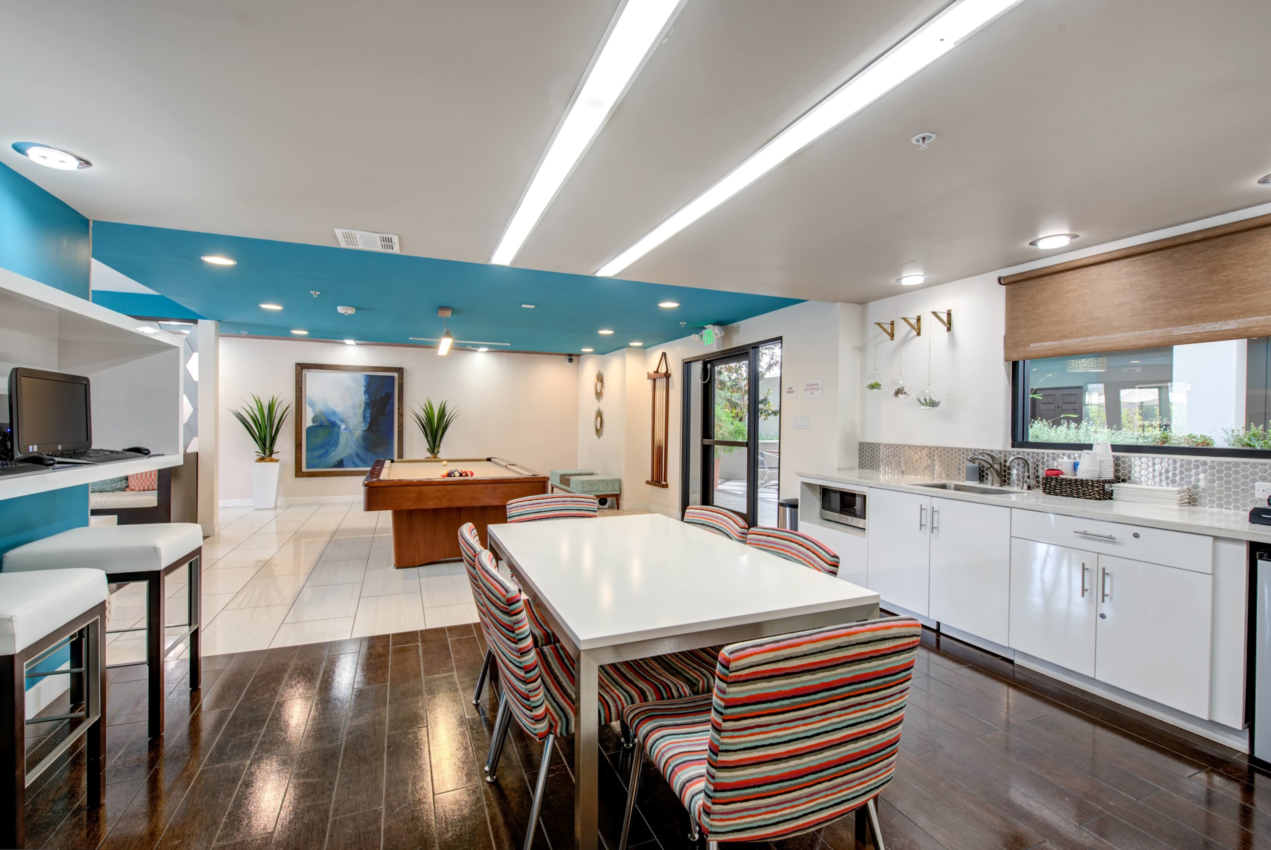 Dining area next to the kitchen sink countertop overlooking the game room at Park Encino