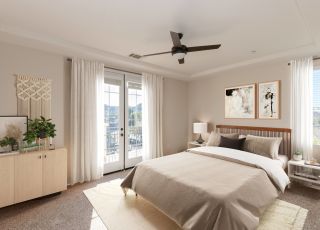Wooden bed frame with cushions and duvet next to side tables and dressers at Rancho Serrano's bedroom