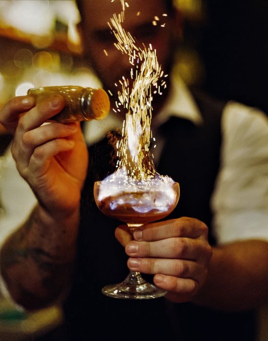 bartender making a fiery drink