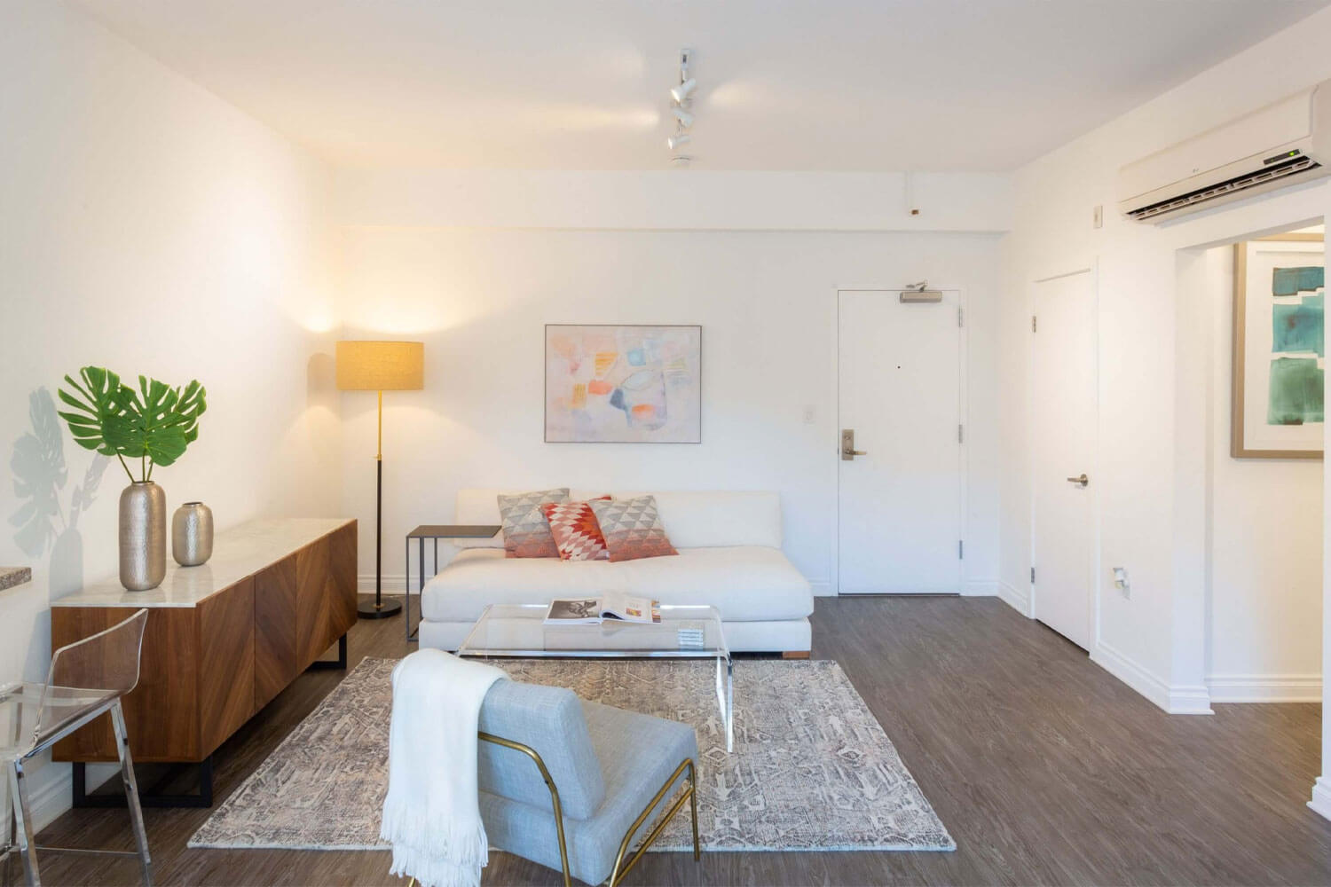 A cozy living room with a comfortable couch, a coffee table, and chairs for relaxation and socializing; Luxury Hollywood Rentals; boutique community apartments in Hollywood