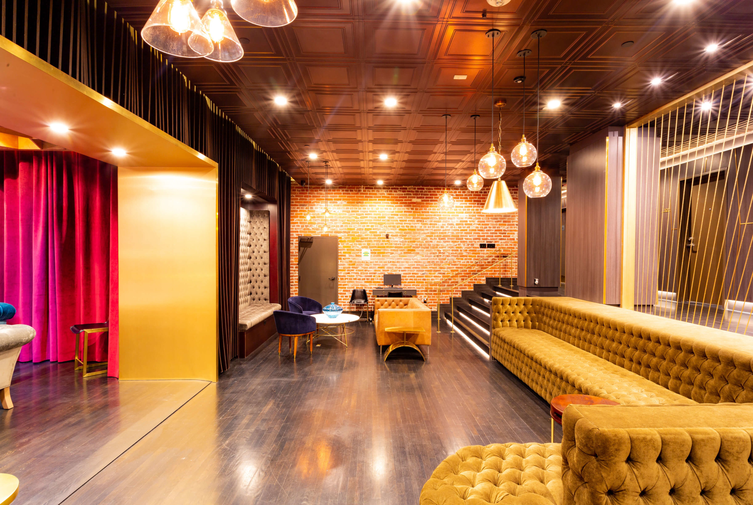 Tufted sofa sectional next to sitting area at The Gershwin Apartments LA