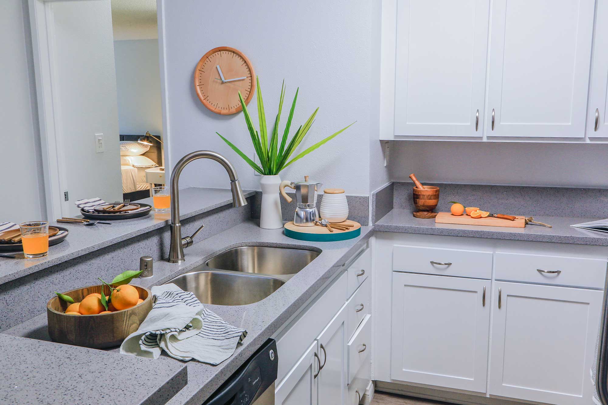 Vive LA Violet on Virgil ;Kitchen countertop with oranges on a wooden bowl and coffee pot on the other side