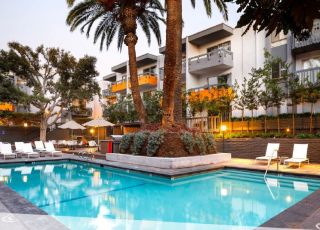 Violet on Virgil building overlooking the outdoor pool and lounge chairs