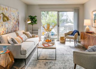 Living room decor at Violet on Virgil next to a wide sliding door leading to the balcony