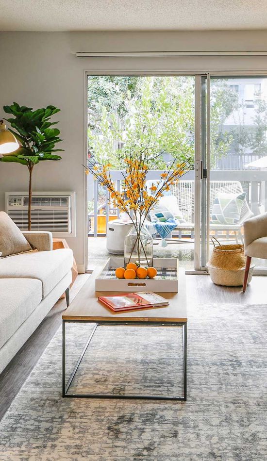 Living room decor at Violet on Virgil next to a wide sliding door leading to the balcony