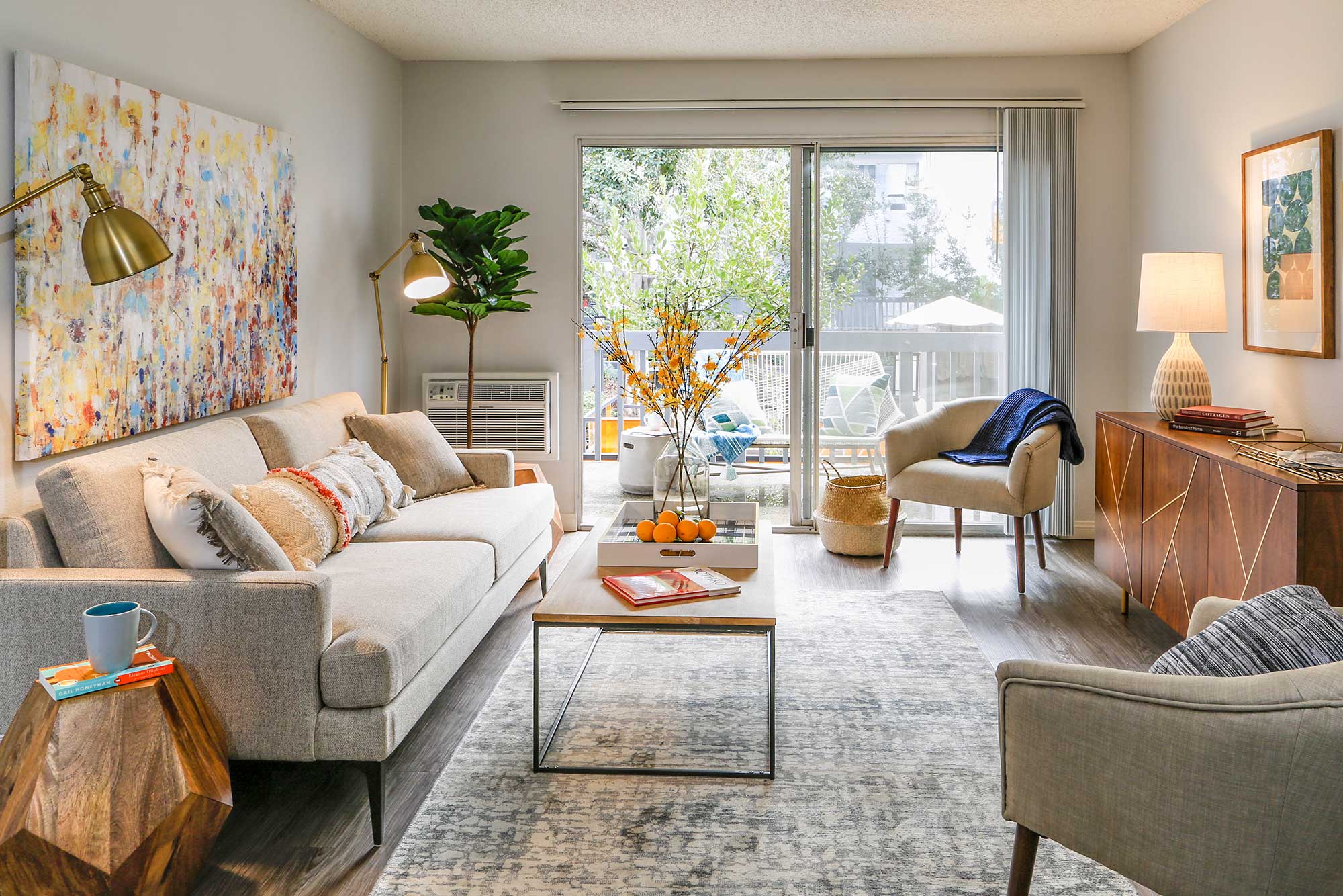 Living room decor at Violet on Virgil next to a wide sliding door leading to the balcony