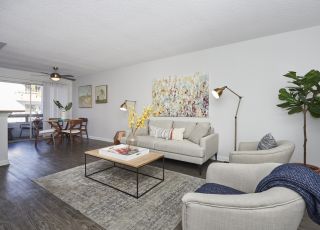 Living room area next to the dining space at Violet on Virgil Apartments