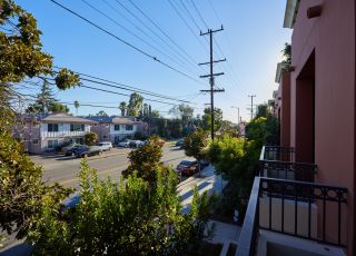 Patio overlooking the street with greenery