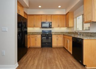 Wide kitchen countertop with wooden cabinets with kitchen appliances