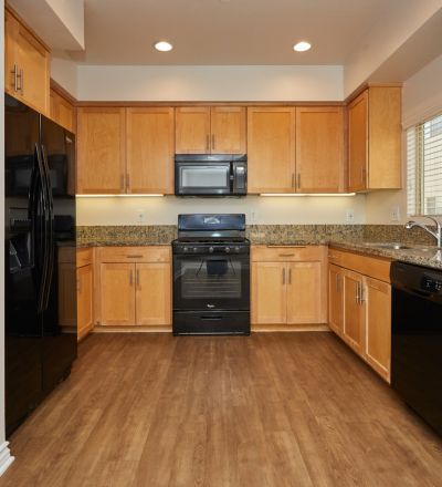 Wide kitchen countertop with wooden cabinets with kitchen appliances