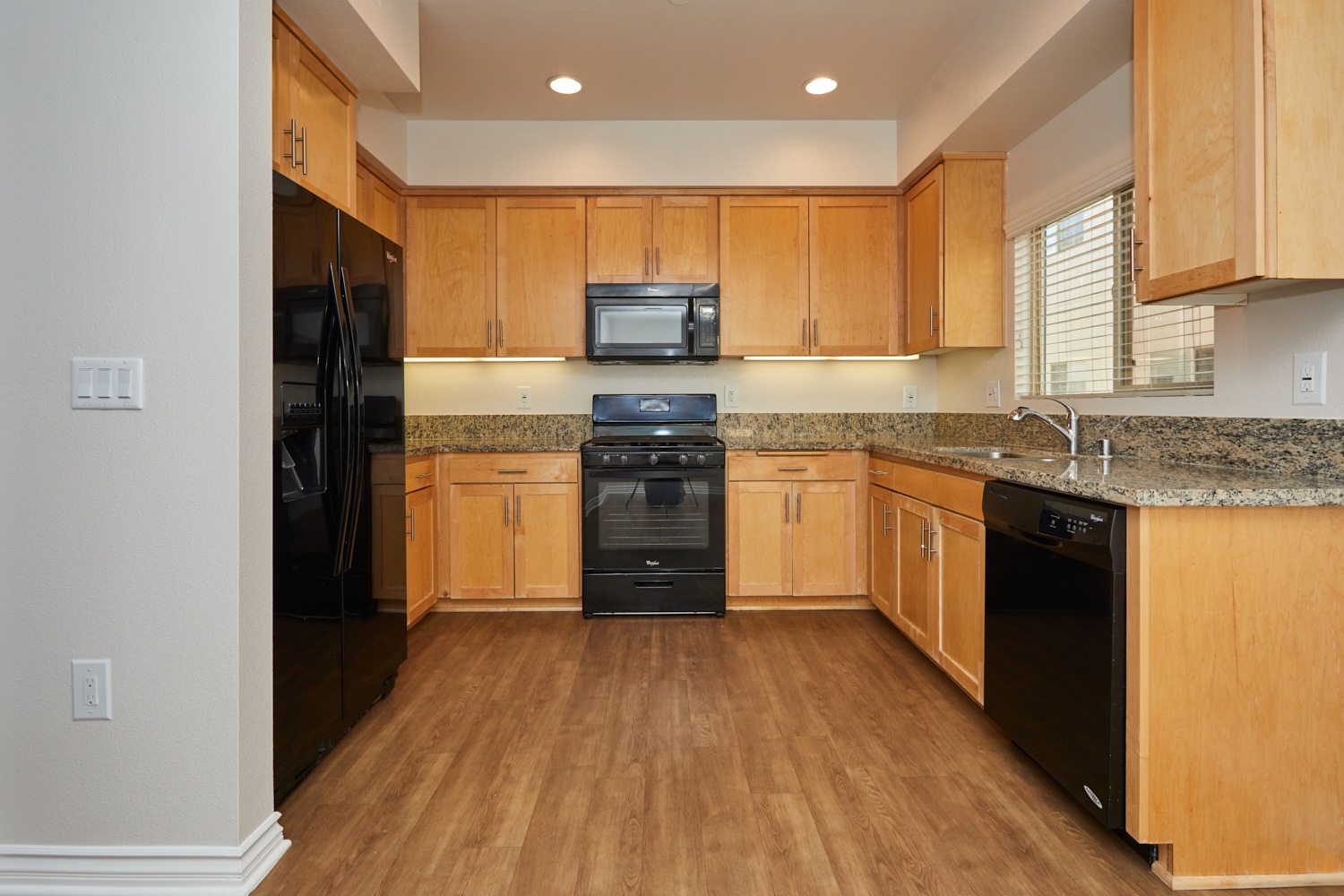Wide kitchen countertop with wooden cabinets with kitchen appliances