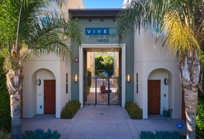 Exterior to the Magnolia Woods townhouses with tall palm trees in the front