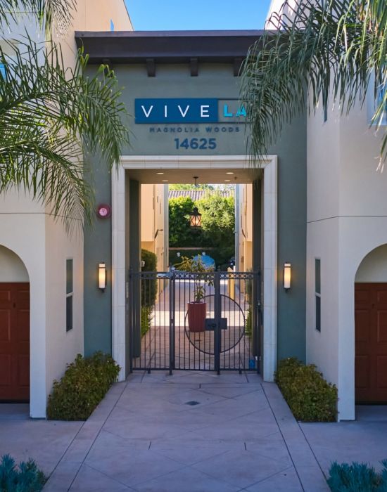 Exterior to the Magnolia Woods townhouses with tall palm trees in the front