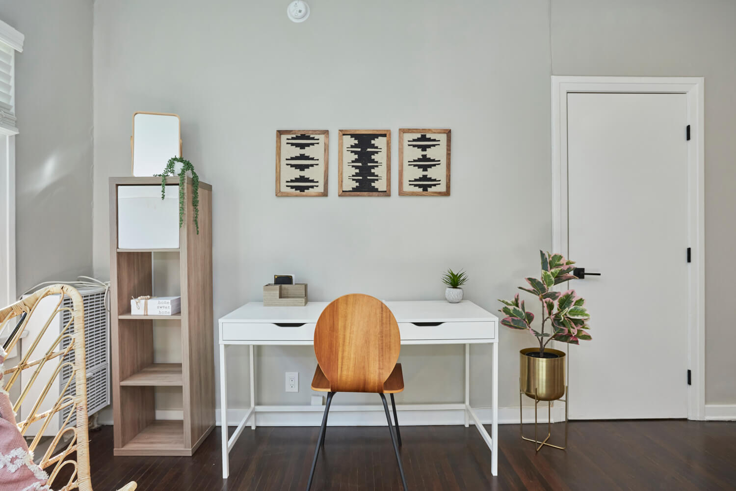 Wide work station with drawers and a wooden chair next to a wooden self and potted plant; Luxury Hollywood Rentals; boutique community apartments in Hollywood