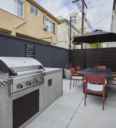 Outdoor barbecue machine placed next to the patio dining table and chairs