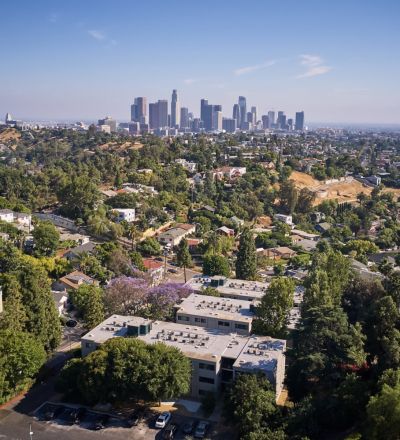 Aerial view of apartment with city skyline in the background; Milo on Morton building