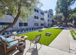 Seating area in backyard; Milo on Morton building exterior