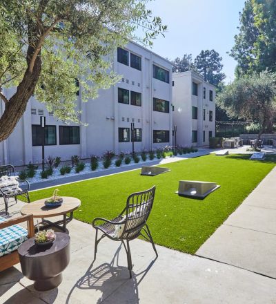 Seating area in backyard; Milo on Morton building exterior