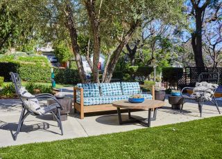 Seating area in backyard; Milo on Morton building exterior