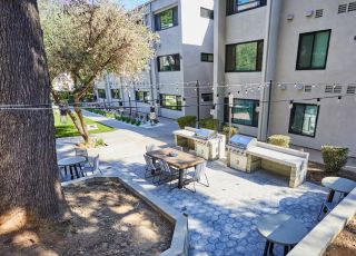Aerial of barbeque & eating area; Milo on Morton building exterior