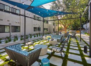Outdoor sitting area under canopy; Milo on Morton building exterior