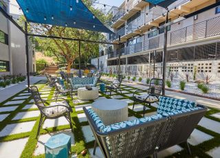 Outdoor sitting area under canopy; Milo on Morton building exterior