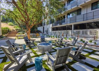 Outdoor fireplace with Adirondack chairs; Milo on Morton building exterior