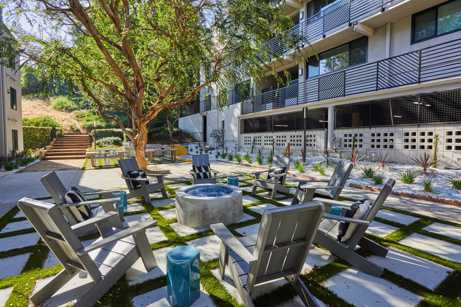 Outdoor fireplace with Adirondack chairs; Milo on Morton building exterior