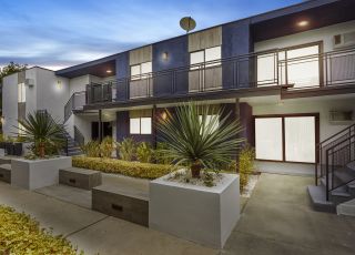 exterior of an apartment building at dusk