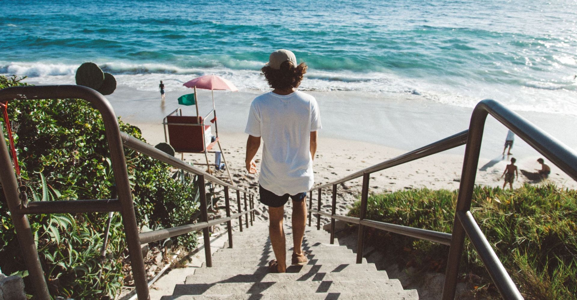someone walking on a boardwalk to the beach