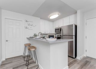Virgil Avenue apartments for rent in Los Angeles; A modern kitchen with sleek stainless steel appliances and warm wooden floors.