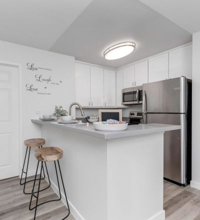 Virgil Avenue apartments for rent in Los Angeles; A modern kitchen with sleek stainless steel appliances and warm wooden floors.