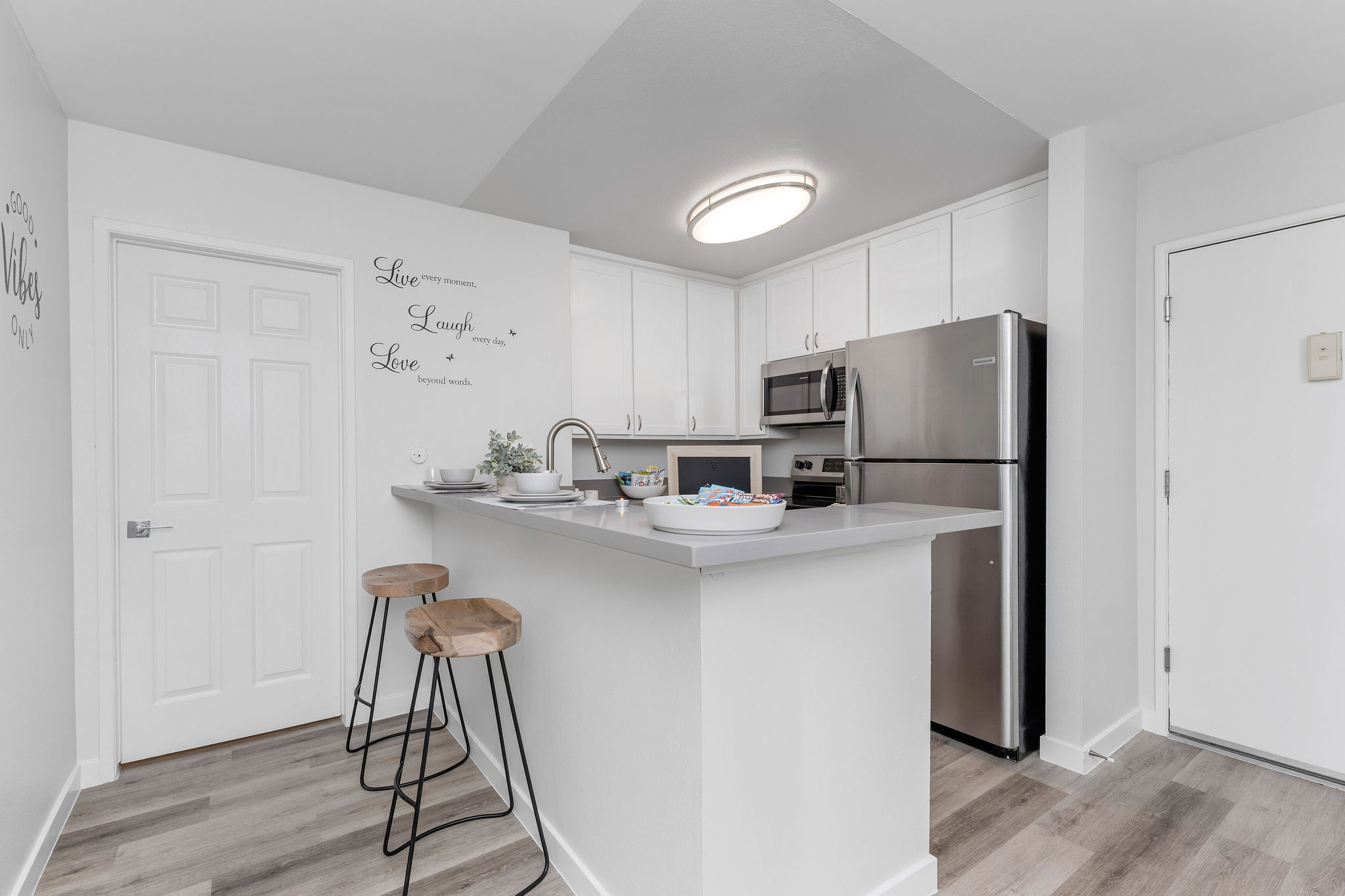 Virgil Avenue apartments for rent in Los Angeles; A modern kitchen with sleek stainless steel appliances and warm wooden floors.
